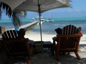 Sitting near a dock in Ambergris Caye, Belize – Best Places In The World To Retire – International Living